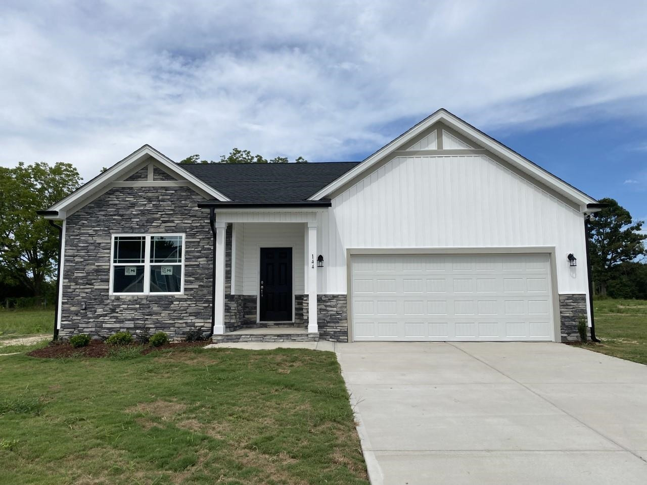 144 Wolf Rdg Court Willow Spring, NC 27592 - Photo 1 of 1 a front view of a house with a yard and garage