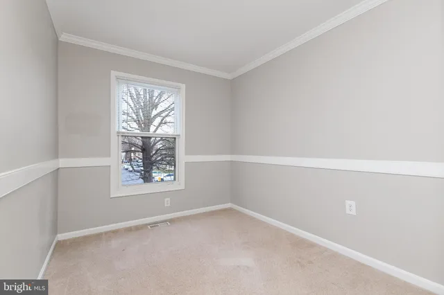 a living room with furniture a rug and a window