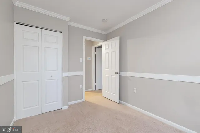 a view of a hallway with entryway and stairs