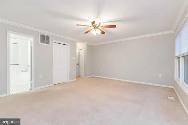 a spacious bedroom with a bed and a couch