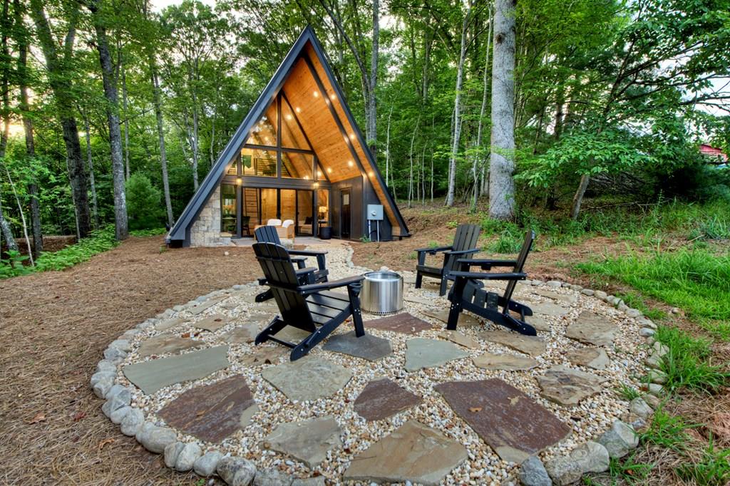 a view of a house with backyard porch and sitting area