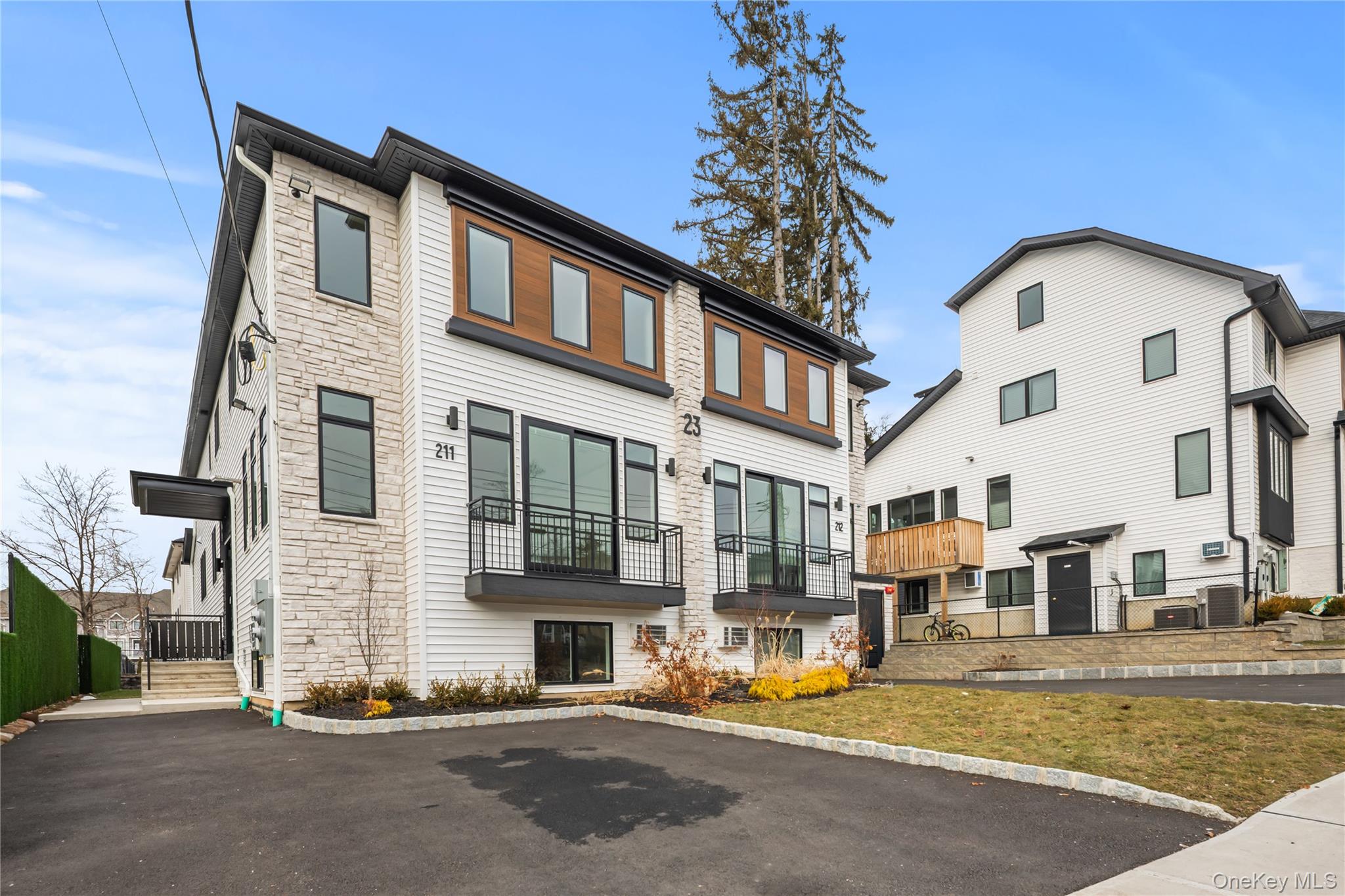 23 Singer Avenue, Unit 211 Spring Valley, NY 10977 - Photo 43 of 45 a front view of a building with street view