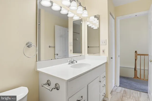a bathroom with a sink vanity and a mirror