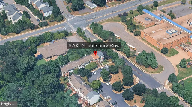 an aerial view of a house with a yard and potted plants