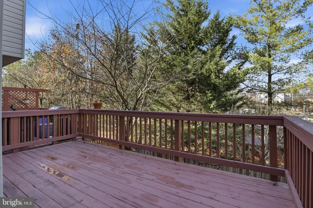 a balcony with wooden floor and fence