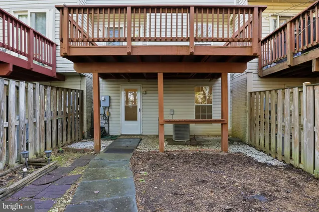 a view of a house with wooden fence