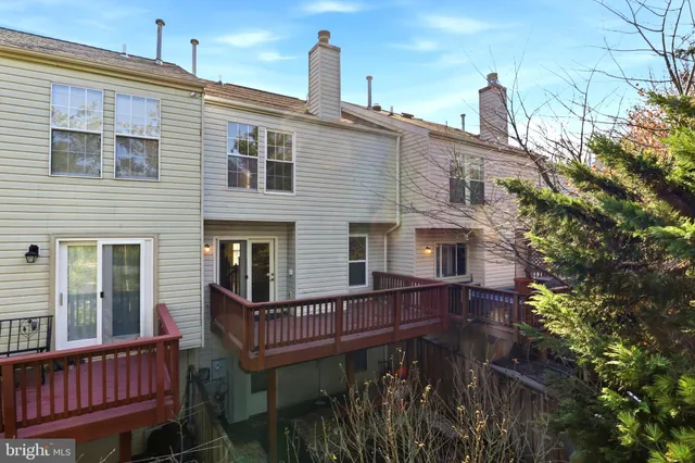 a view of a house with a wooden deck