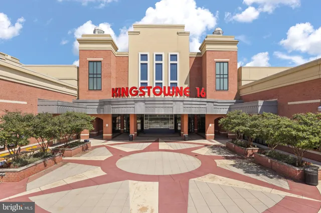 a wooden bench sitting in front of a building