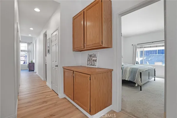 a hallway with a large mirror and a sink
