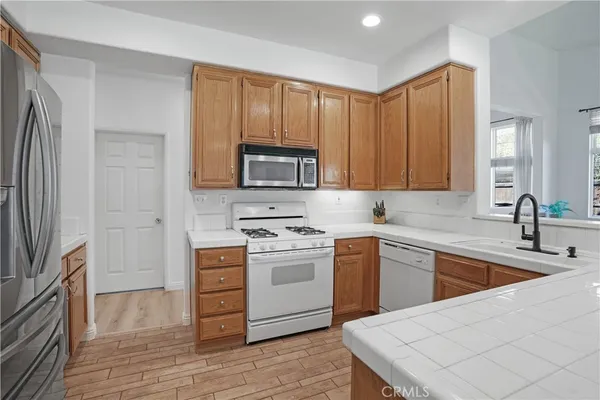 a kitchen with a sink stove and refrigerator