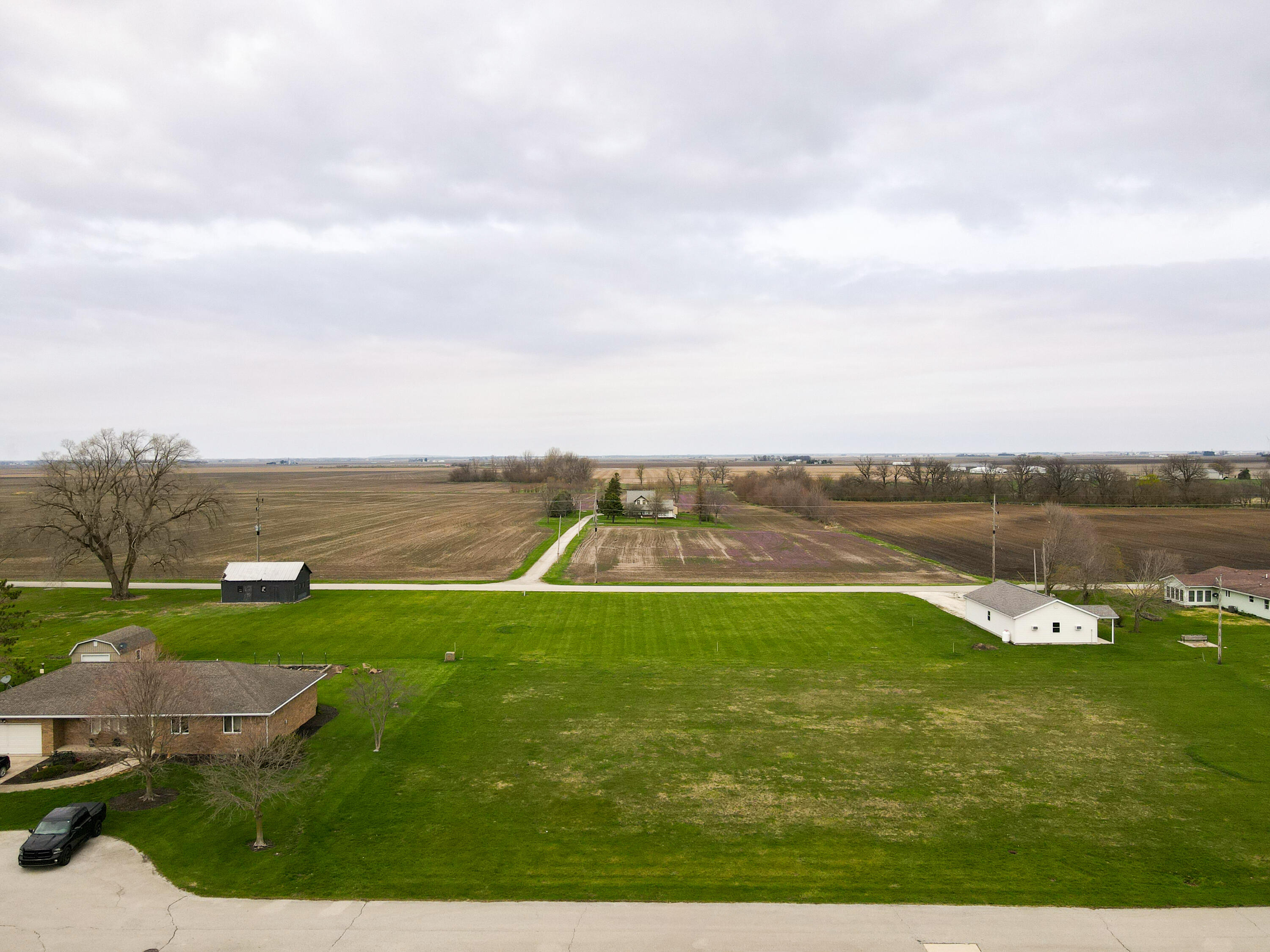 6 East Brook Street Goodland, IN 47948 - Photo 4 of 7 a view of a lake with houses in the back