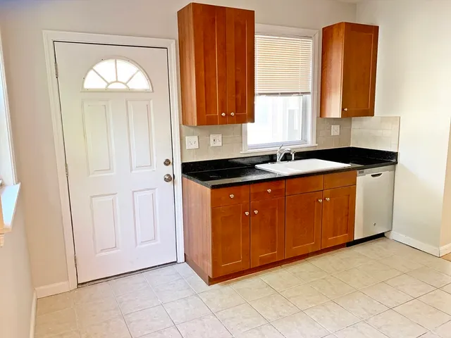 a kitchen with stainless steel appliances granite countertop a sink a stove and a refrigerator