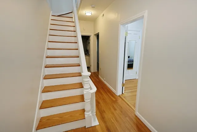 a view of a workspace with furniture and wooden floor