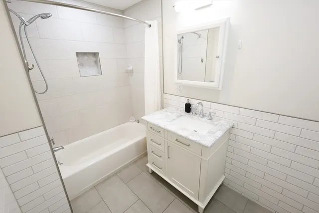 a bathroom with a shower and a bath tub