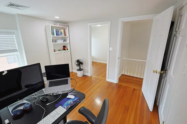 a white toilet sitting next to a bathroom sink and vanity
