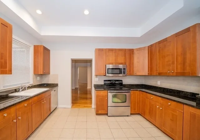 a view of a house with wooden fence