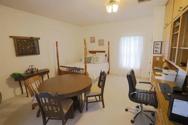 a view of a dining room with furniture and a window