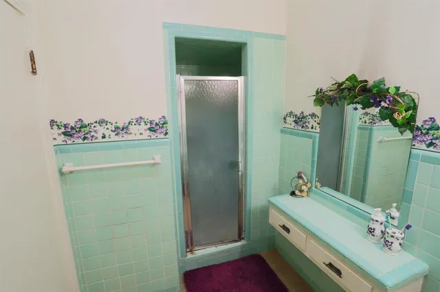 a bathroom with a bathtub sink and mirror