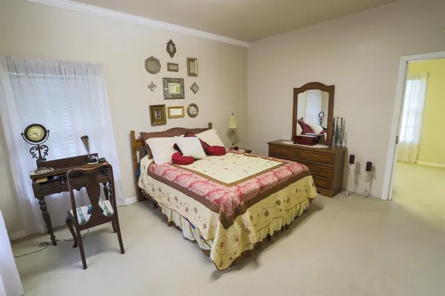 a bedroom with a bed and a dresser in it