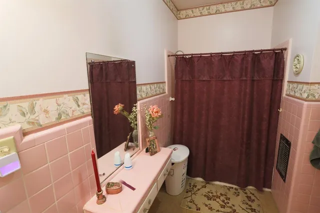 a view of a patio with table and chairs with wooden floor and fence