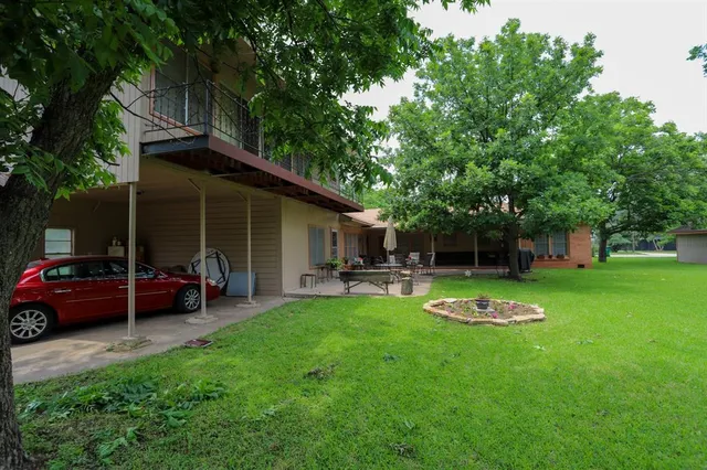 a big yard with large trees