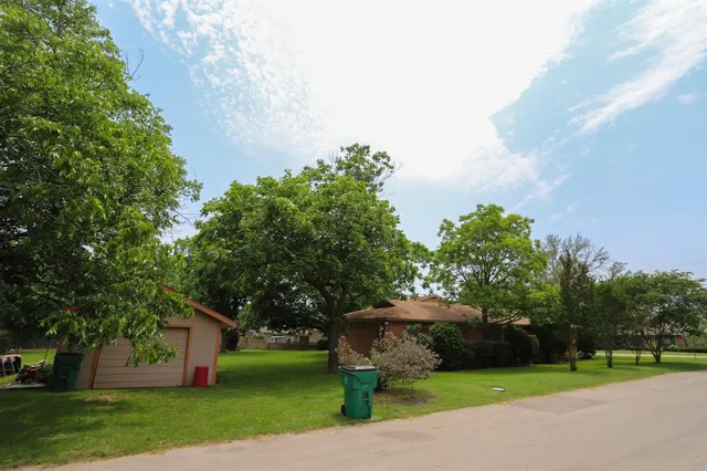 an aerial view of multiple houses with yard