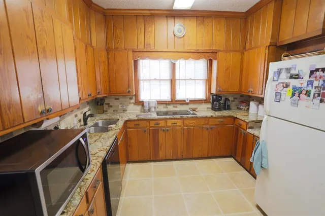 a utility room with cabinets washer and dryer