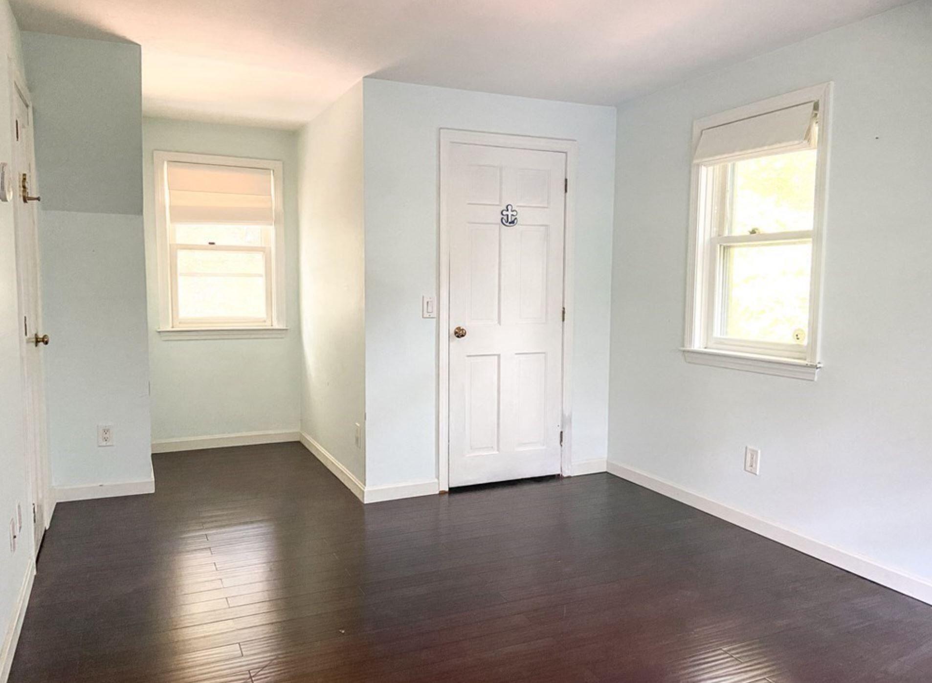 577 Lumbert Mill Road Osterville, MA 02655 - Photo 13 of 22 an empty room with wooden floor and windows