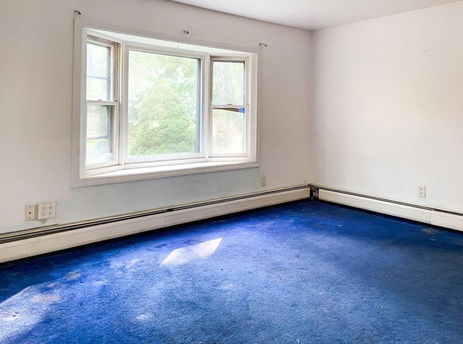 577 Lumbert Mill Road Osterville, MA 02655 - Photo 15 of 22 an empty room with wooden floor and windows