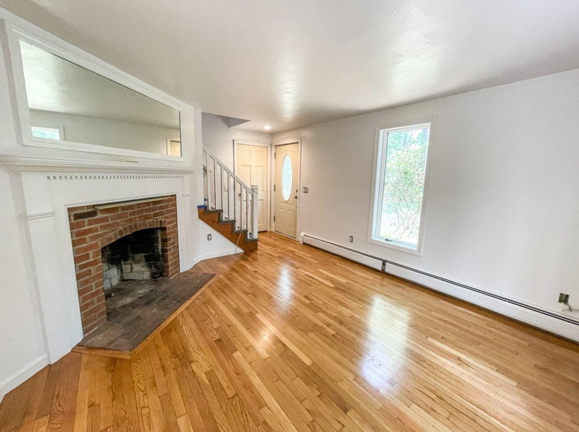 577 Lumbert Mill Road Osterville, MA 02655 - Photo 17 of 22 a view of empty room with wooden floor and fireplace