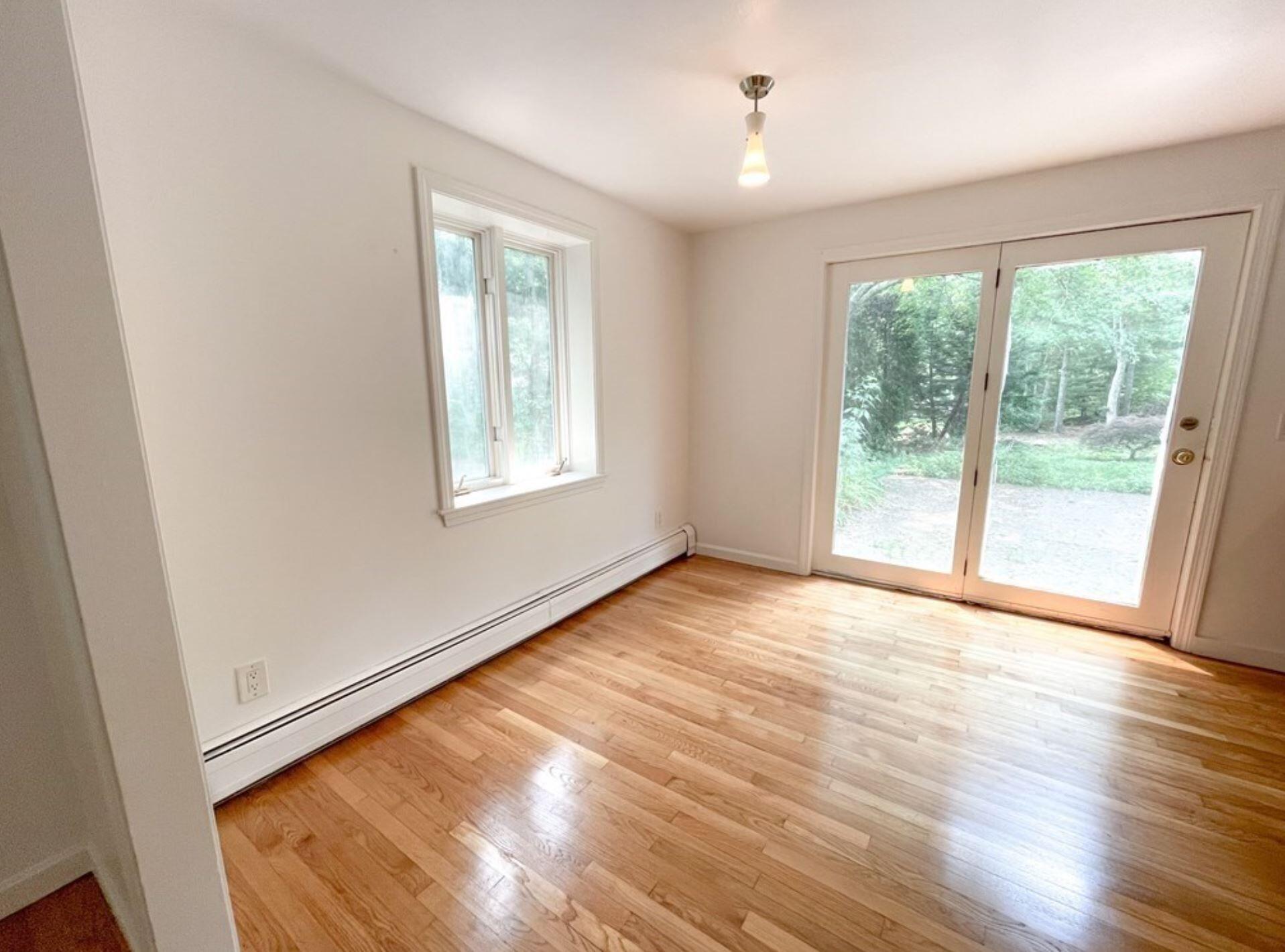 577 Lumbert Mill Road Osterville, MA 02655 - Photo 18 of 22 an empty room with wooden floor and windows