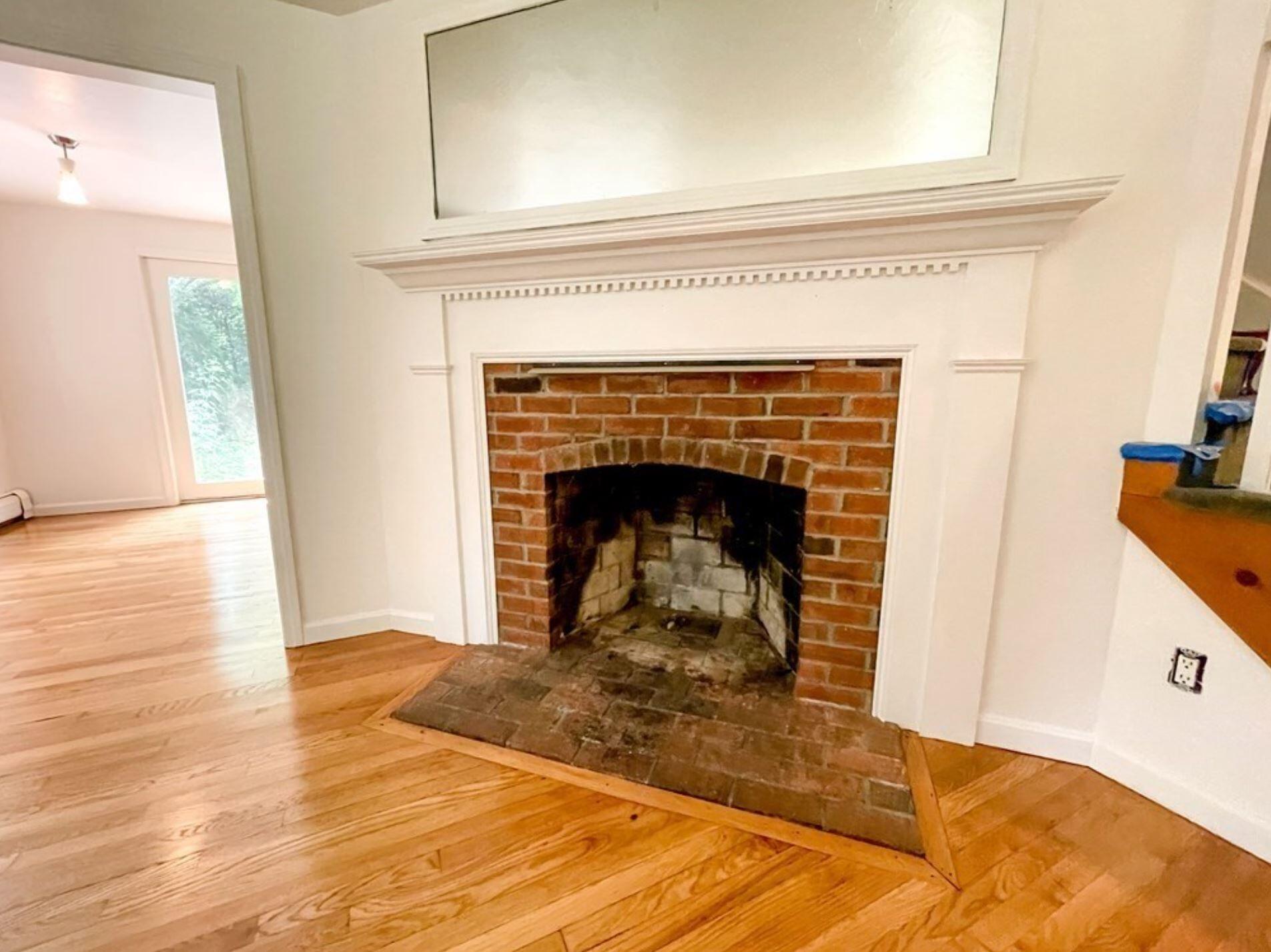 577 Lumbert Mill Road Osterville, MA 02655 - Photo 20 of 22 a view of a livingroom with wooden floor and a fireplace