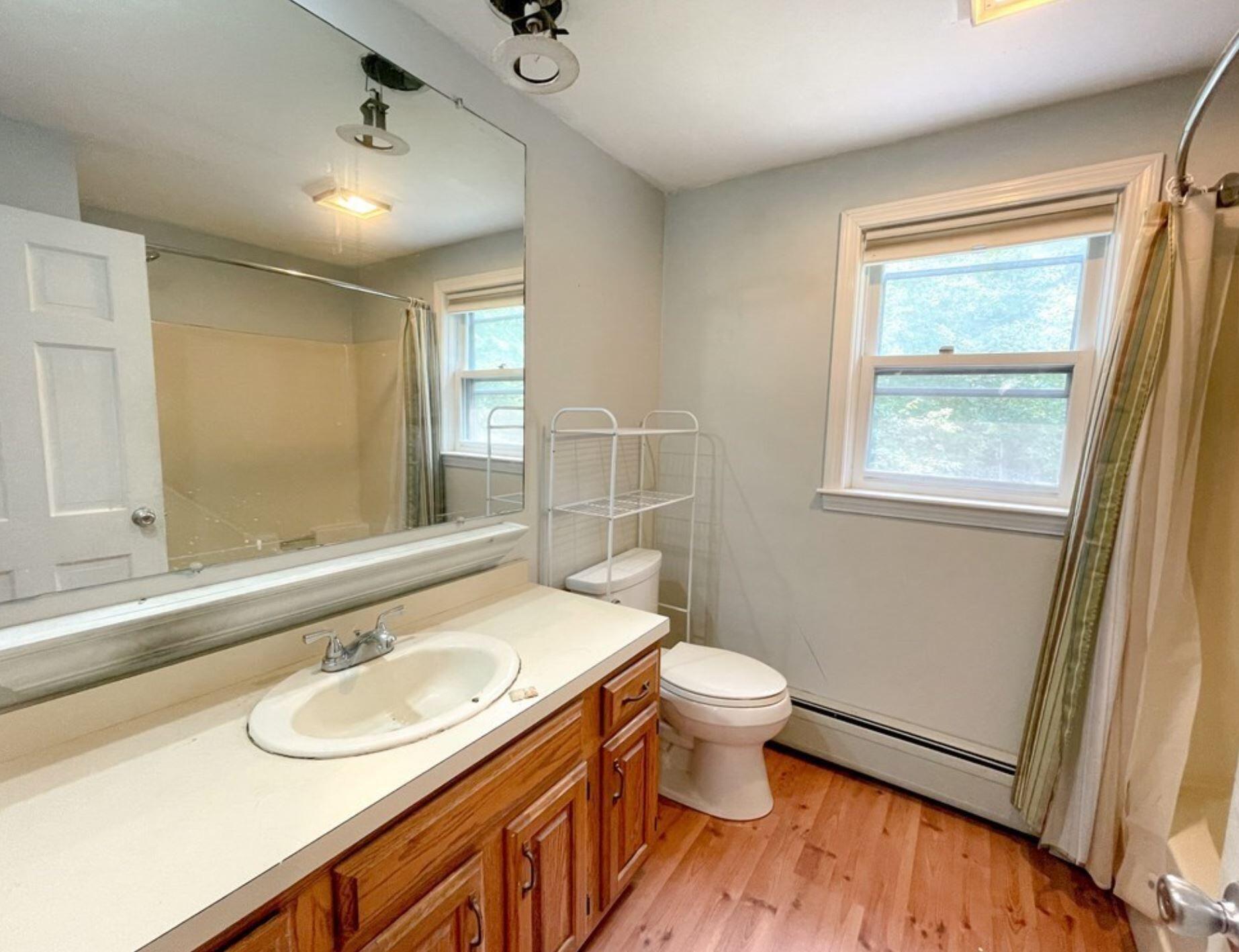 577 Lumbert Mill Road Osterville, MA 02655 - Photo 21 of 22 a bathroom with a sink toilet a mirror and vanity