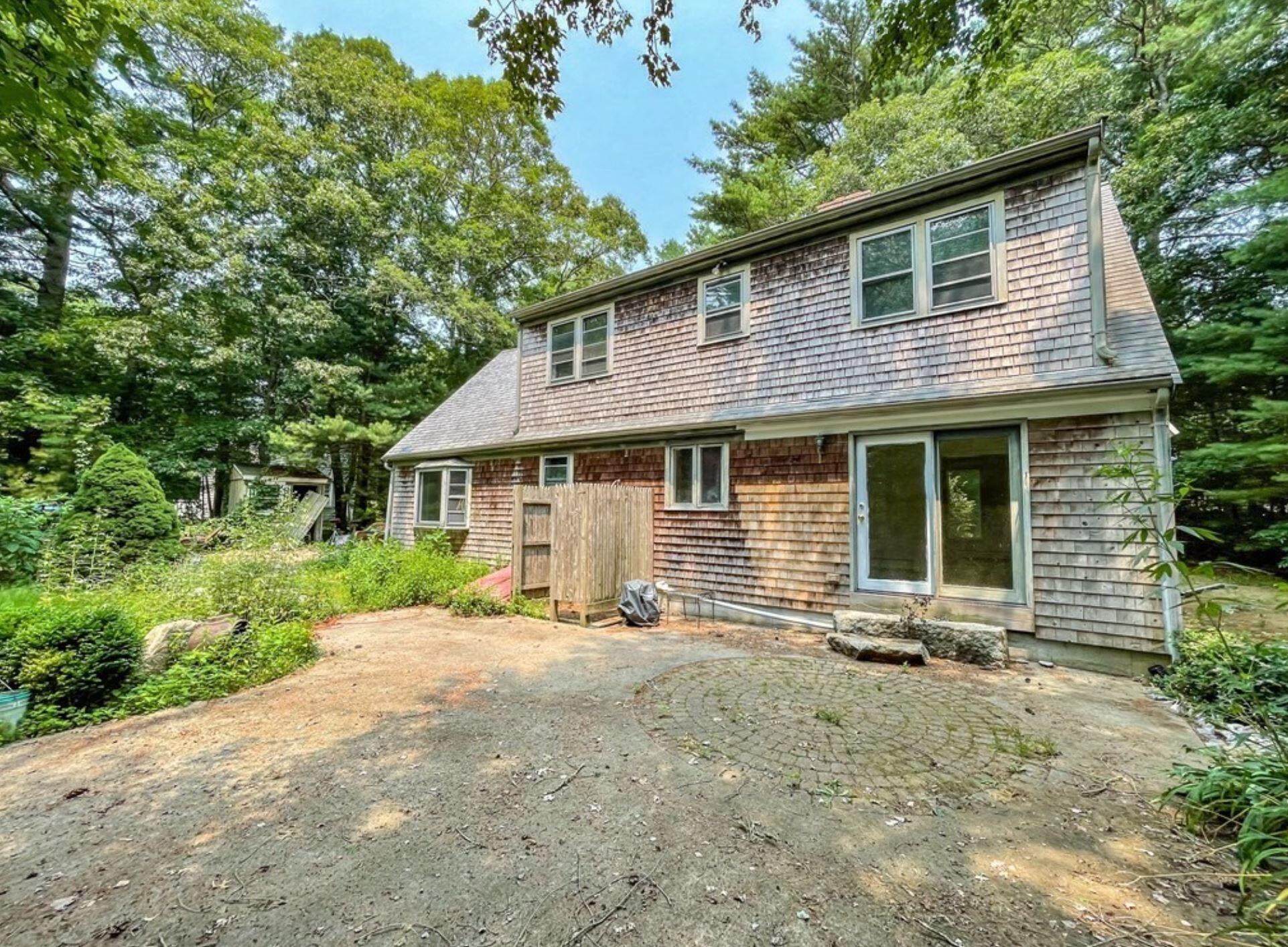 577 Lumbert Mill Road Osterville, MA 02655 - Photo 3 of 22 a front view of a house with yard patio and garden