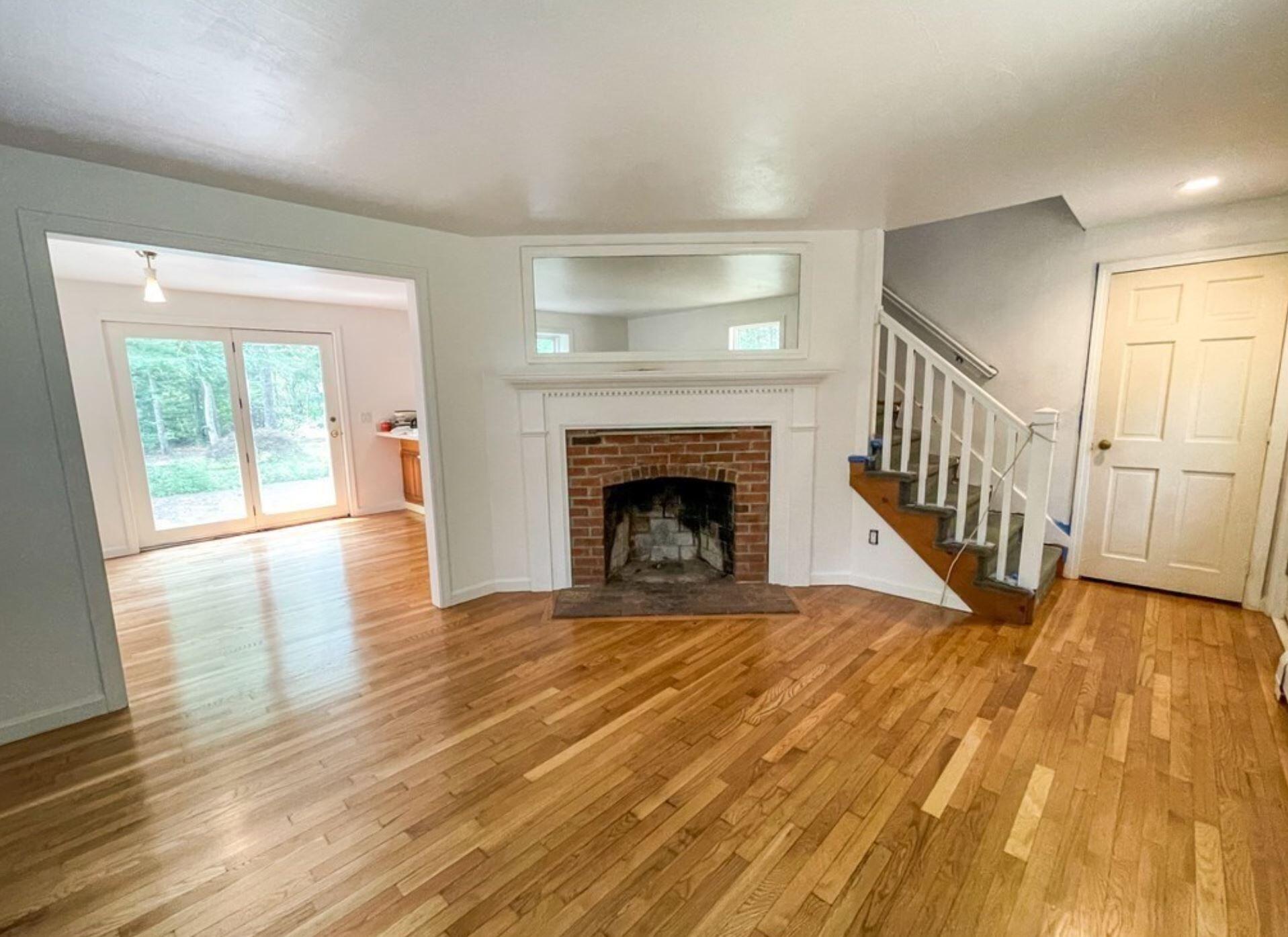 577 Lumbert Mill Road Osterville, MA 02655 - Photo 4 of 22 a view of empty room with wooden floor and fireplace