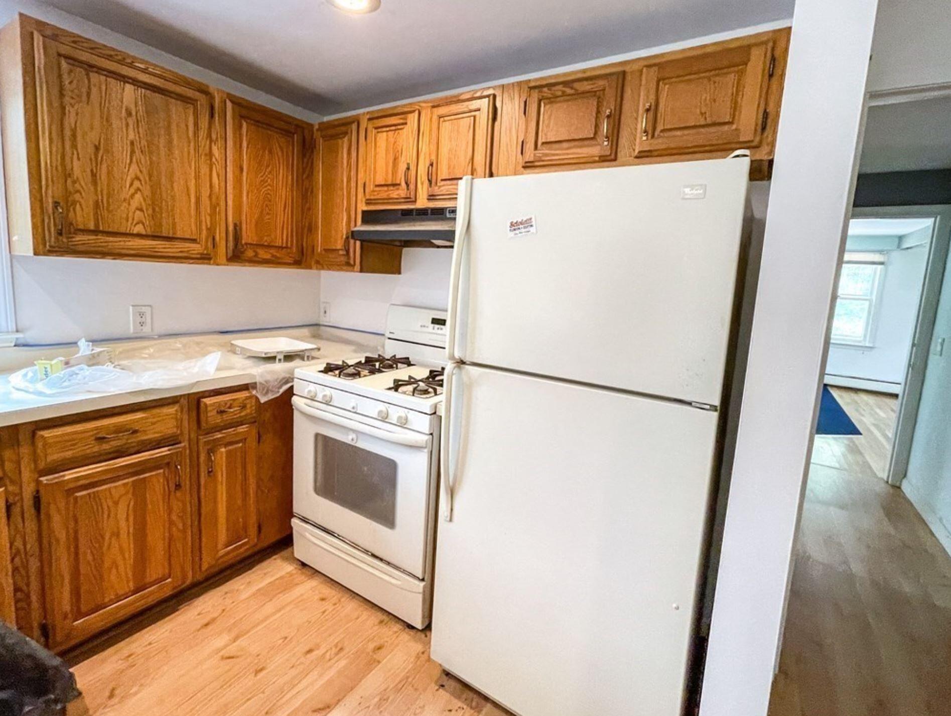 577 Lumbert Mill Road Osterville, MA 02655 - Photo 5 of 22 a kitchen with a refrigerator sink stove and cabinets