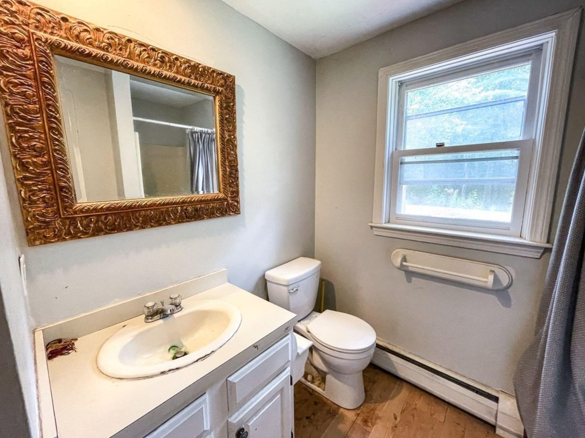 577 Lumbert Mill Road Osterville, MA 02655 - Photo 6 of 22 a bathroom with a toilet sink vanity and mirror