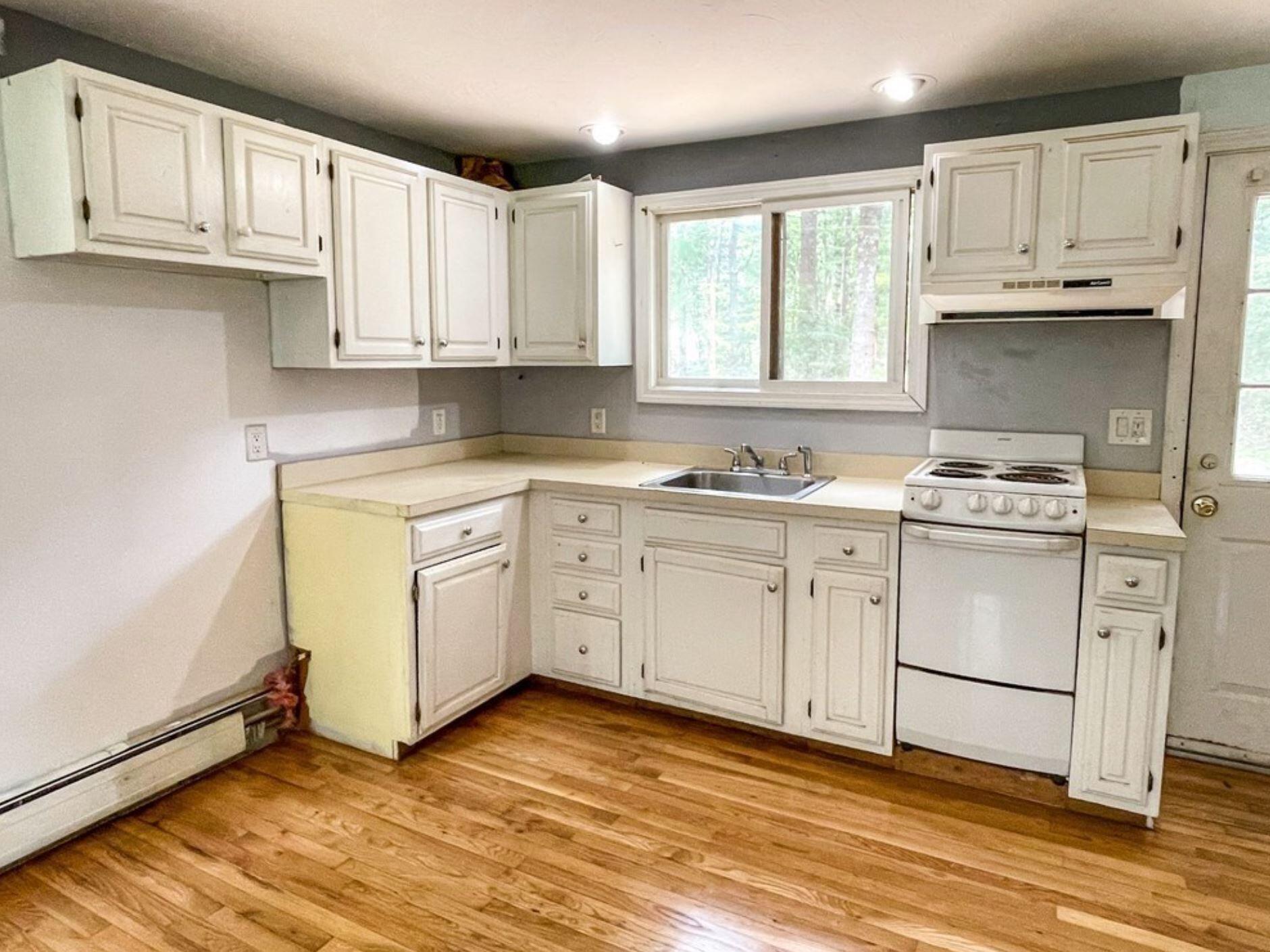 577 Lumbert Mill Road Osterville, MA 02655 - Photo 7 of 22 a kitchen with cabinets appliances a sink and a window