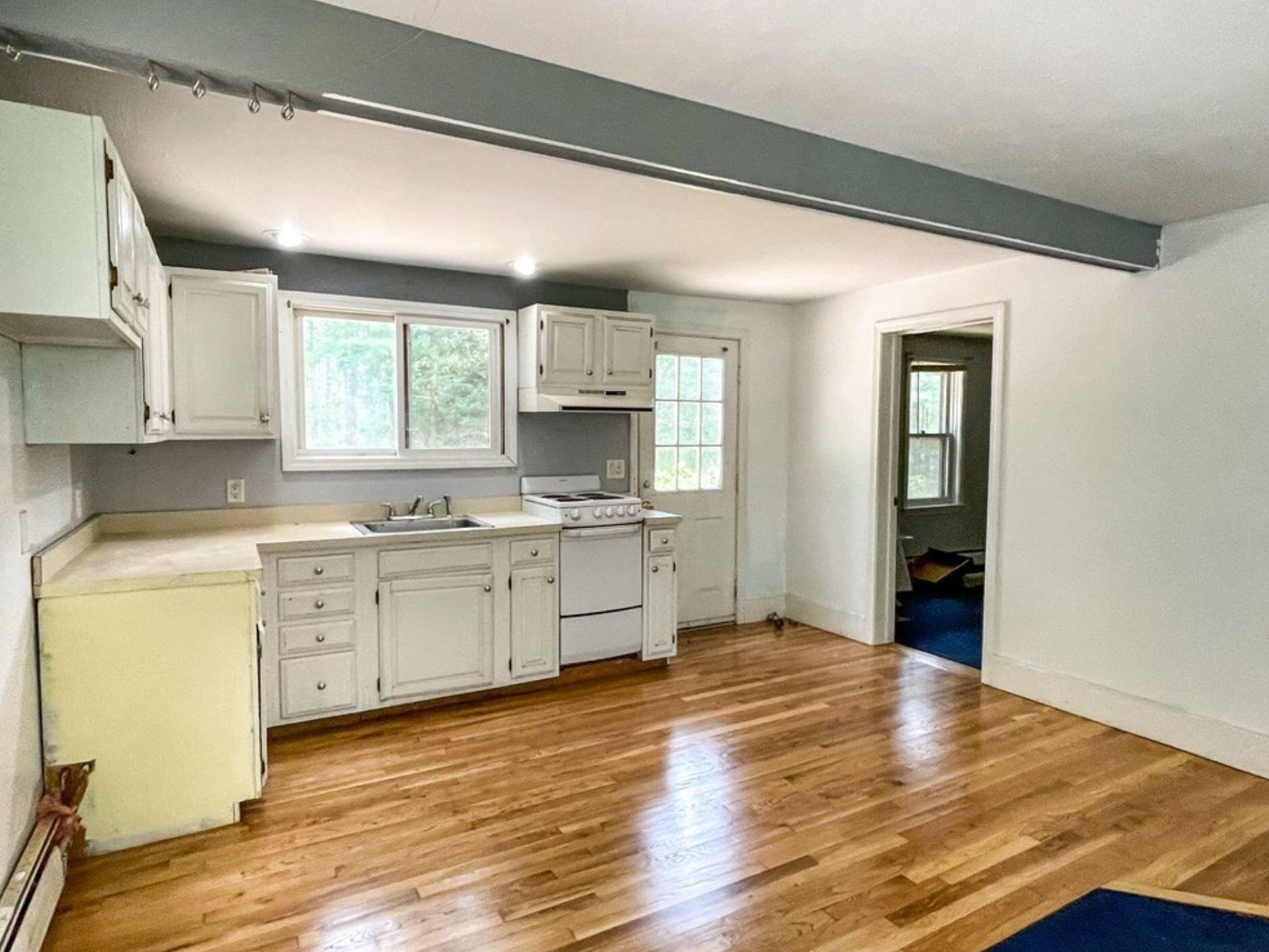 577 Lumbert Mill Road Osterville, MA 02655 - Photo 8 of 22 a kitchen with granite countertop white cabinets and white appliances