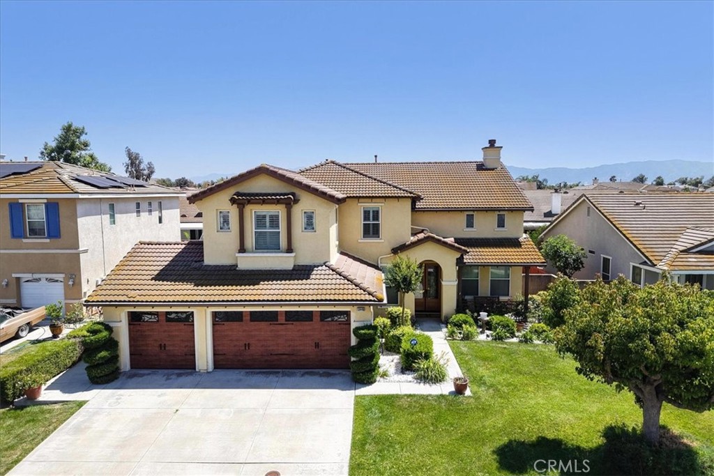 13449 Quail Run Road Eastvale, CA 92880 - Photo 1 of 59 a front view of a house with a yard