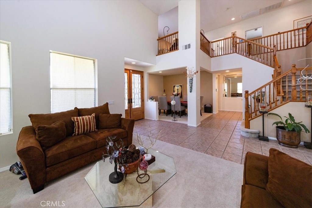 13449 Quail Run Road Eastvale, CA 92880 - Photo 16 of 59 a living room with furniture ceiling fan and a window