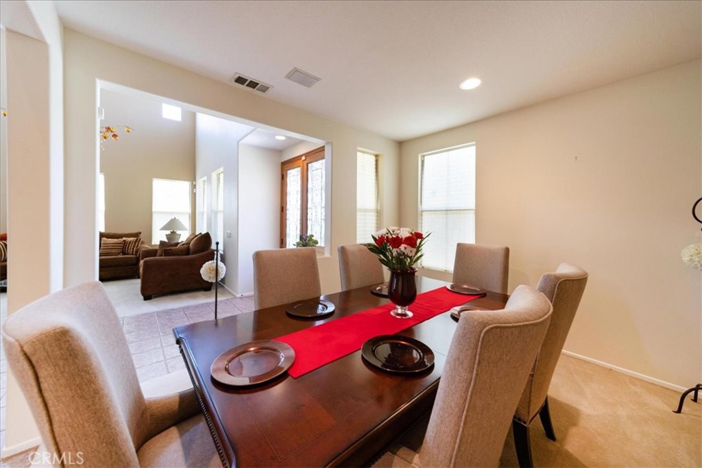 13449 Quail Run Road Eastvale, CA 92880 - Photo 18 of 59 a view of a dining room with furniture and a large window
