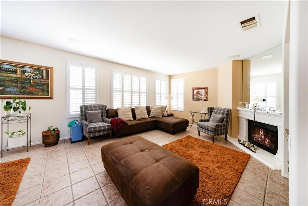13449 Quail Run Road Eastvale, CA 92880 - Photo 20 of 59 a living room with furniture and a fireplace