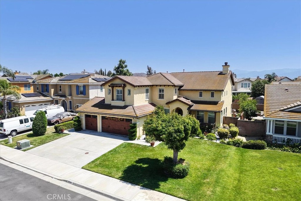 13449 Quail Run Road Eastvale, CA 92880 - Photo 2 of 59 a front view of a house with a garden and plants