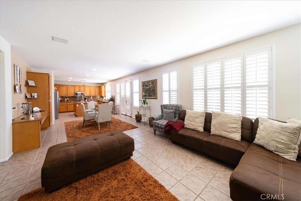 13449 Quail Run Road Eastvale, CA 92880 - Photo 21 of 59 a living room with furniture and a large window