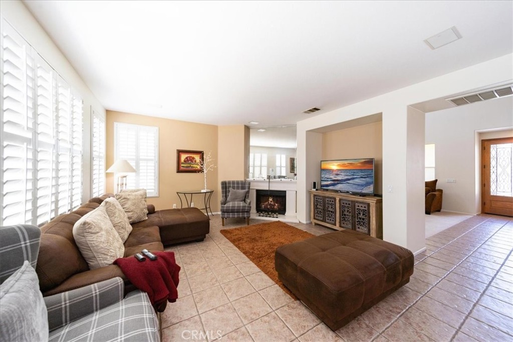 13449 Quail Run Road Eastvale, CA 92880 - Photo 22 of 59 a living room with furniture and a flat screen tv