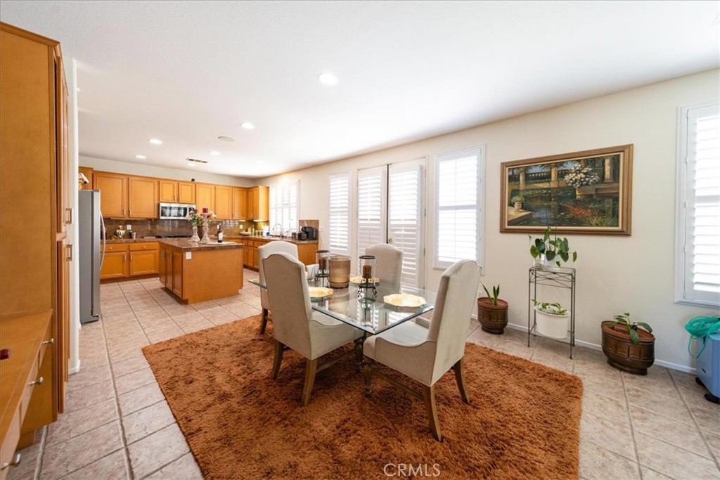 13449 Quail Run Road Eastvale, CA 92880 - Photo 23 of 59 a living room with furniture a rug and a window