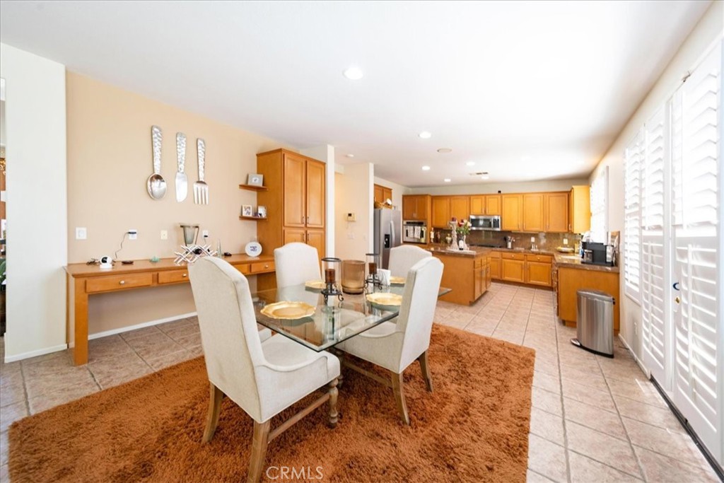 13449 Quail Run Road Eastvale, CA 92880 - Photo 24 of 59 a living room with furniture kitchen view and a large window