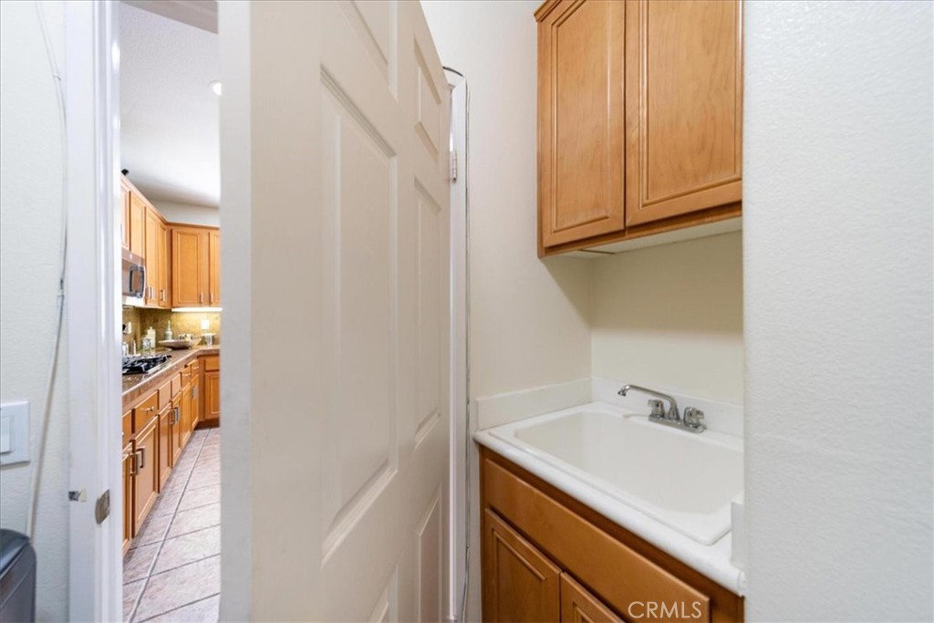 13449 Quail Run Road Eastvale, CA 92880 - Photo 30 of 59 a bathroom with a sink and a mirror