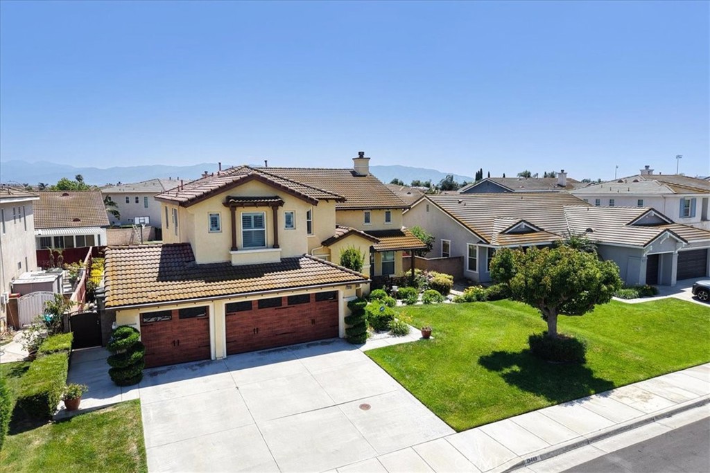 13449 Quail Run Road Eastvale, CA 92880 - Photo 3 of 59 a front view of a house with a garden